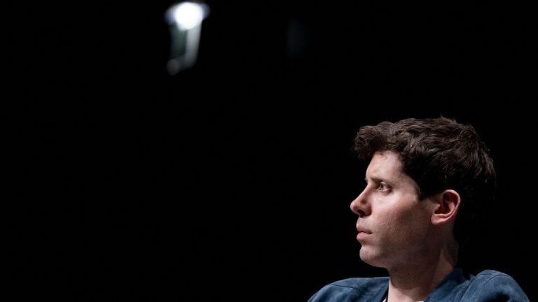 Sam Altman, OpenAI CEO, sits on stage during a meeting