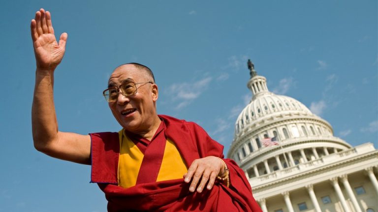 The Dalia Lama waves in front of the Capitol