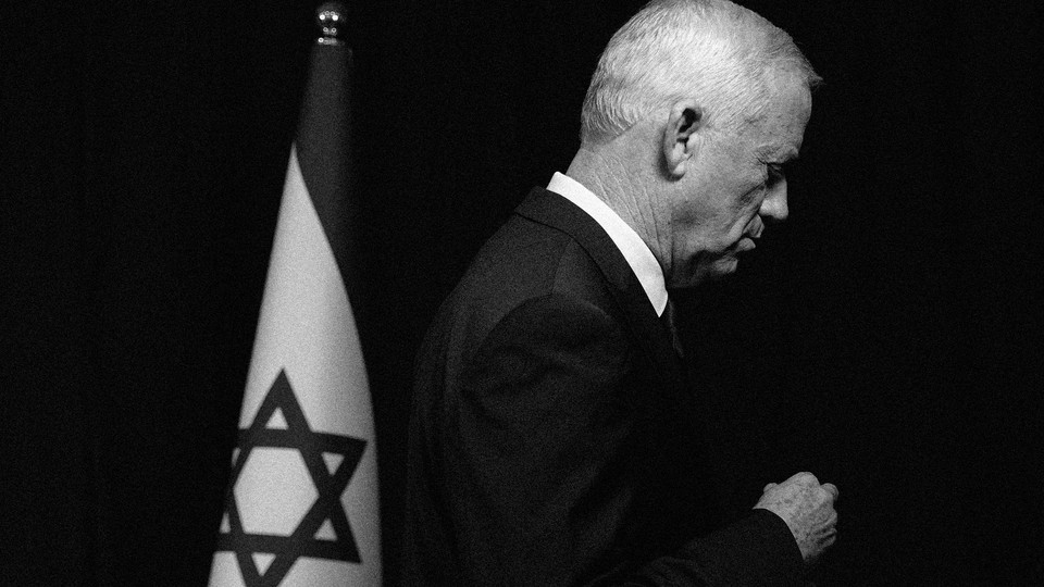 Benny Gantz in profile next to an Israeli flag