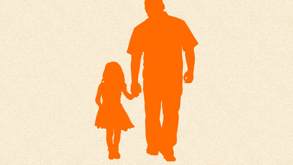 A father holds his daughter's hand