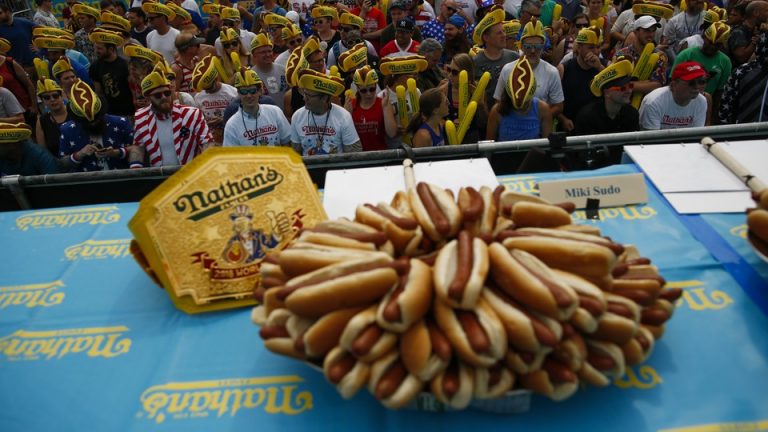 People wearing hot-dog hats attend the Annual Nathan's Hot Dog Eating Contest in 2018 in Coney Island