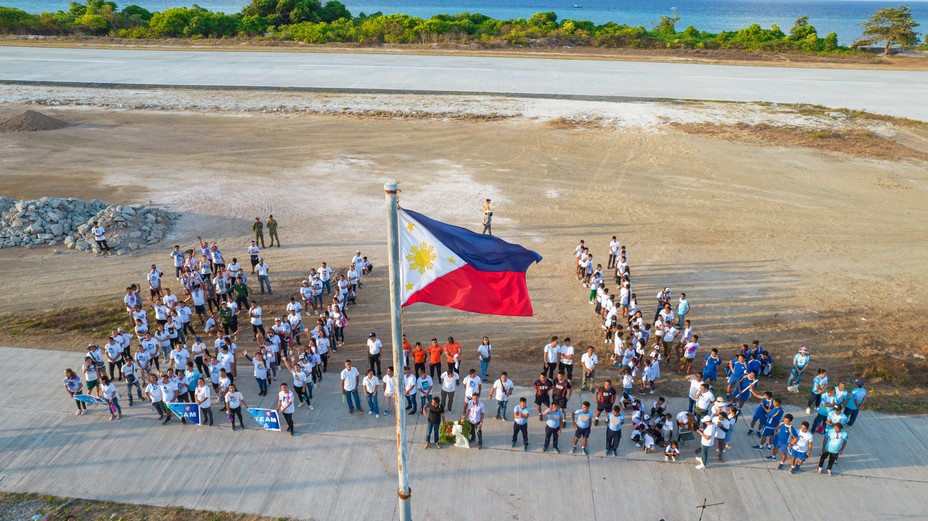 Government officials and residents of Thitu Island attends the flag raising ceremony