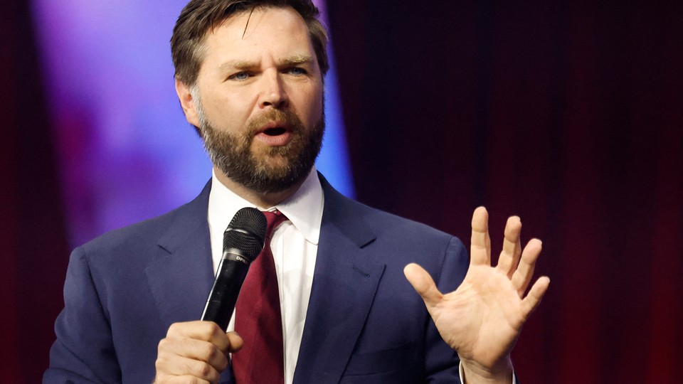 A photo of J. D. Vance speaking while holding a microphone