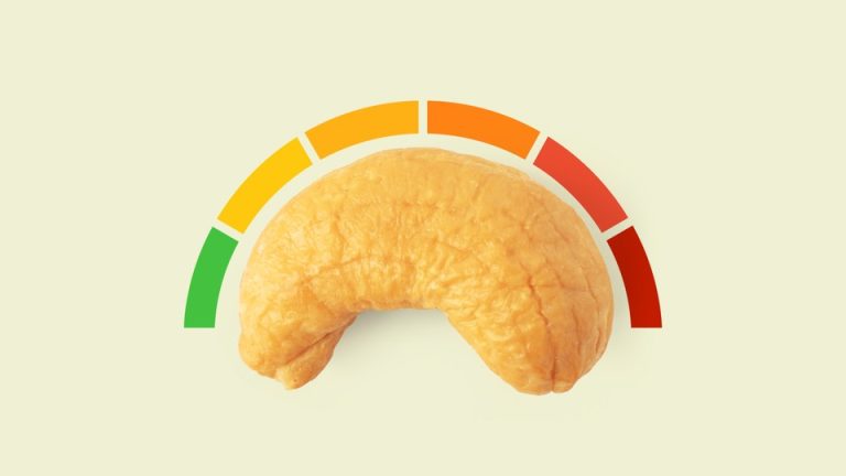 A cashew with a rating system curving above it, ranging from green to red.