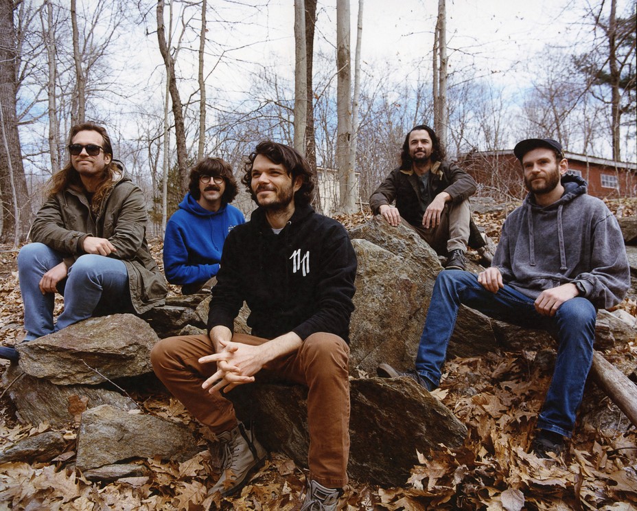 Members of Goose pose for a portrait outside their studio