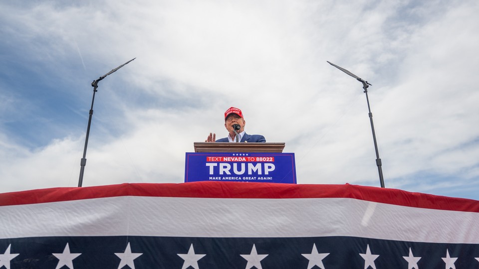 Donald Trump speaks from a podium during his campaign rally