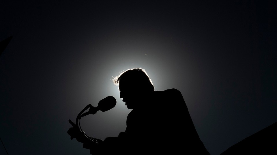 The silhouette of Donald Trump as he speaks during a rally