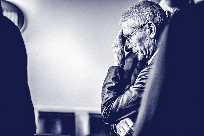 photo of Fauci touching his forehead with his hand over face while standing