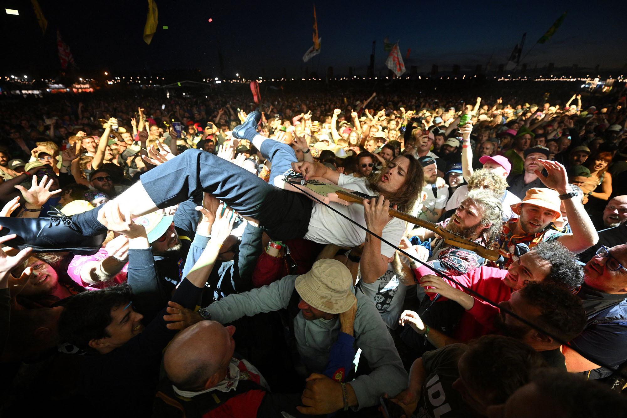 Lee Kiernan of the band Idles jumps into the crowd during their performance