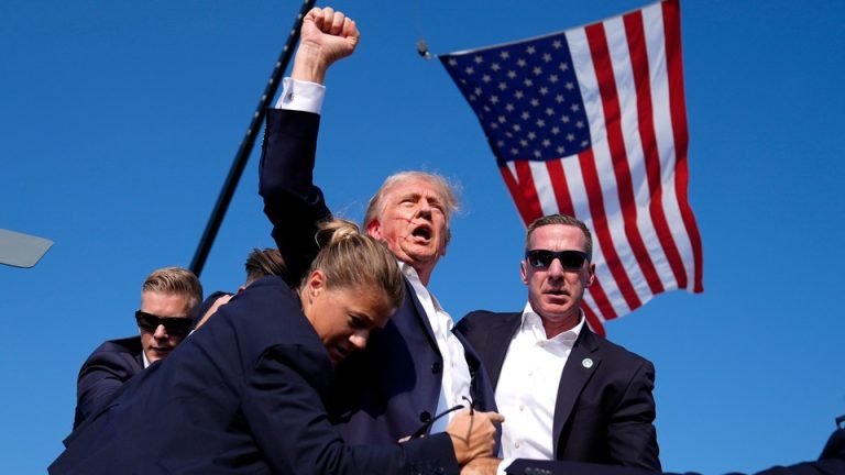 Donald Trump with blood on his face, raising his fist, after an assassination attempt at his rally