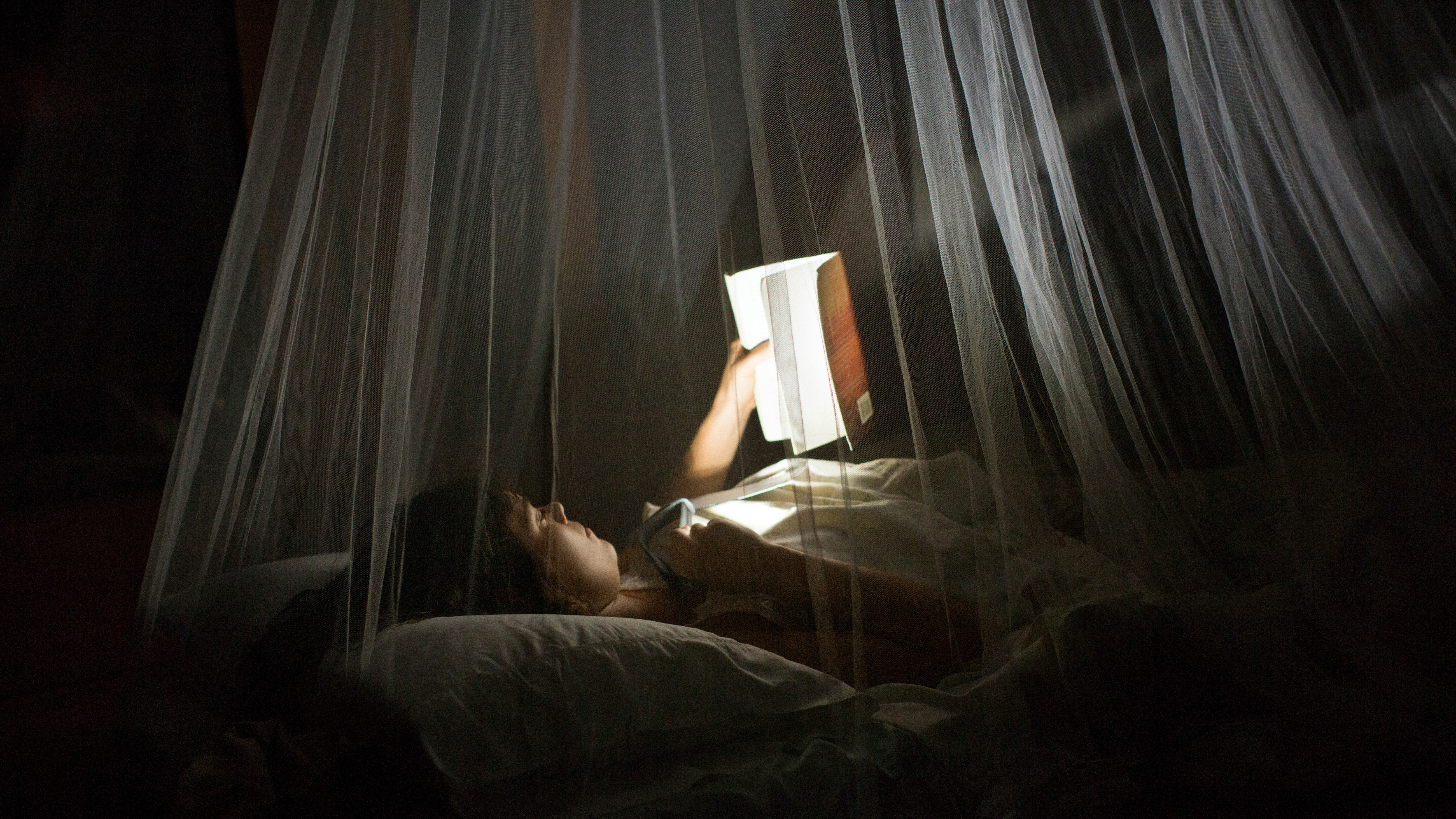 A person reading in the dark