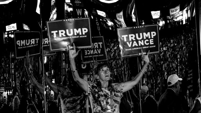 Woman with Trump/Vance signs