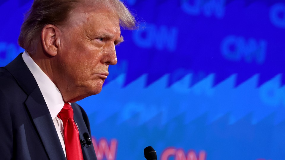 Donald Trump stands in front of a microphone during CNN's presidential debate