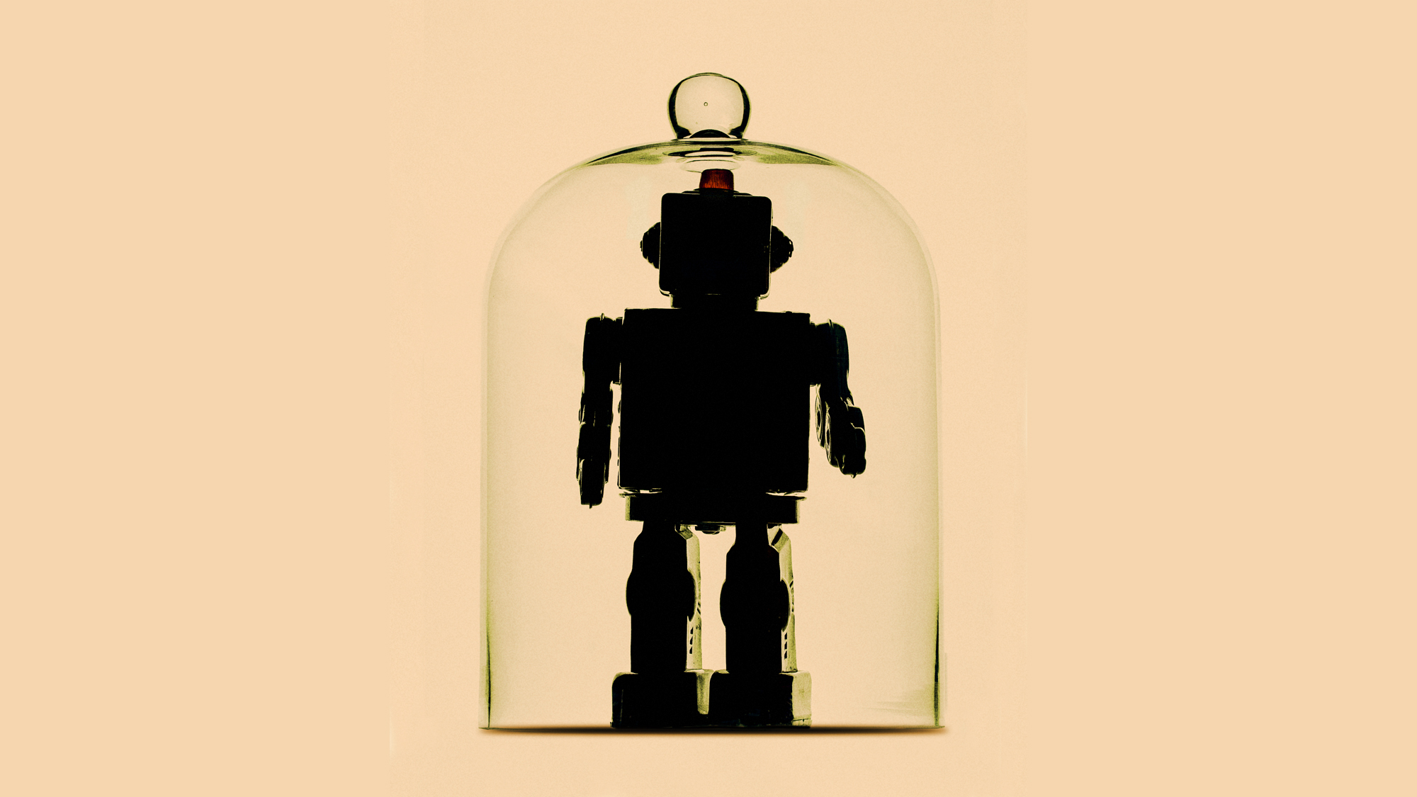 A humanoid robot inside a bell jar