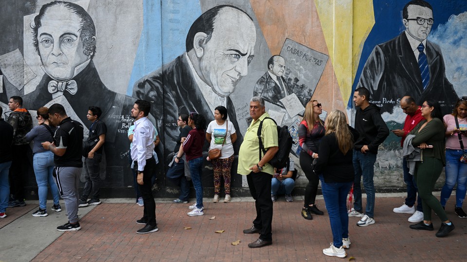 People queue to vote outside a polling station during a mock election in Caracas on June 30, 2024. (Federico Parra / AFP / Getty)