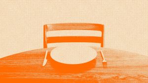 An orange image of an empty chair and an empty plate on a table