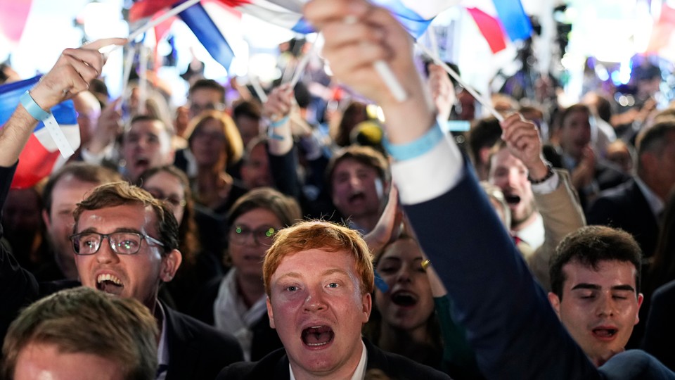 Supporters of the far-right National Rally celebrate the European election results in Paris on June 9.