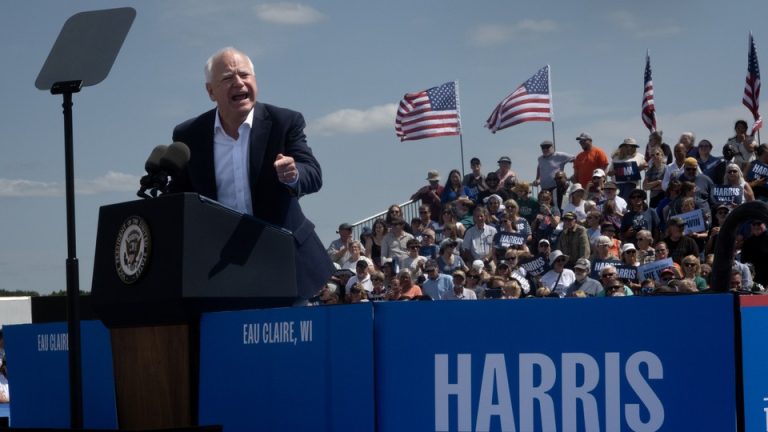 Tim Walz speaks at a campaign event in front of a crowd