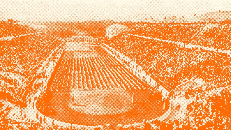 An image of the stadium in Athens filled with people (with an orange tint)