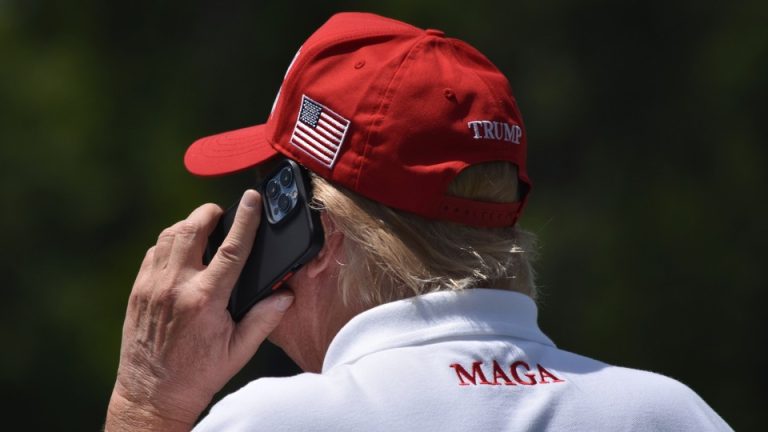 The back of Donald Trump's head, with a red MAGA cap