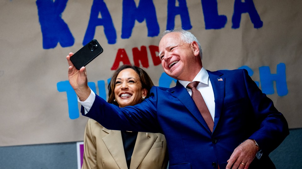 Kamala Harris and Tim Walz smile for a selfie