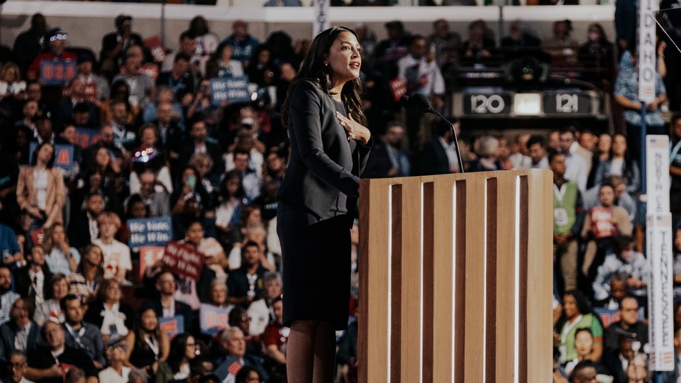 AOC speaking behind a lectern