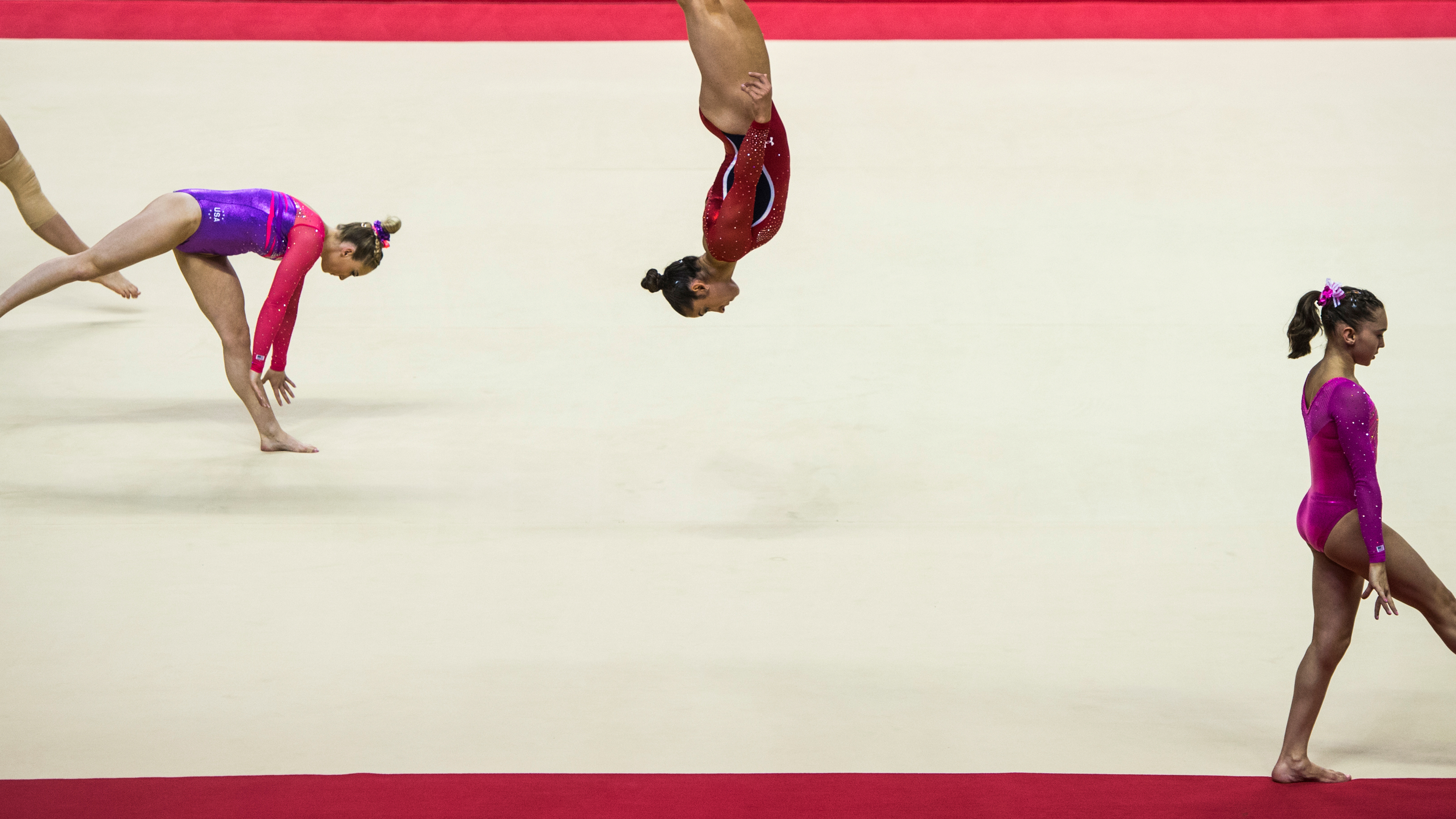 photo of several gymnasts warming up