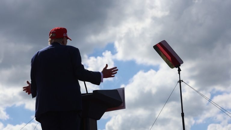 Trump speaking to a podium