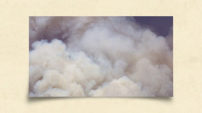 Clouds of smoke in front of a blue sky