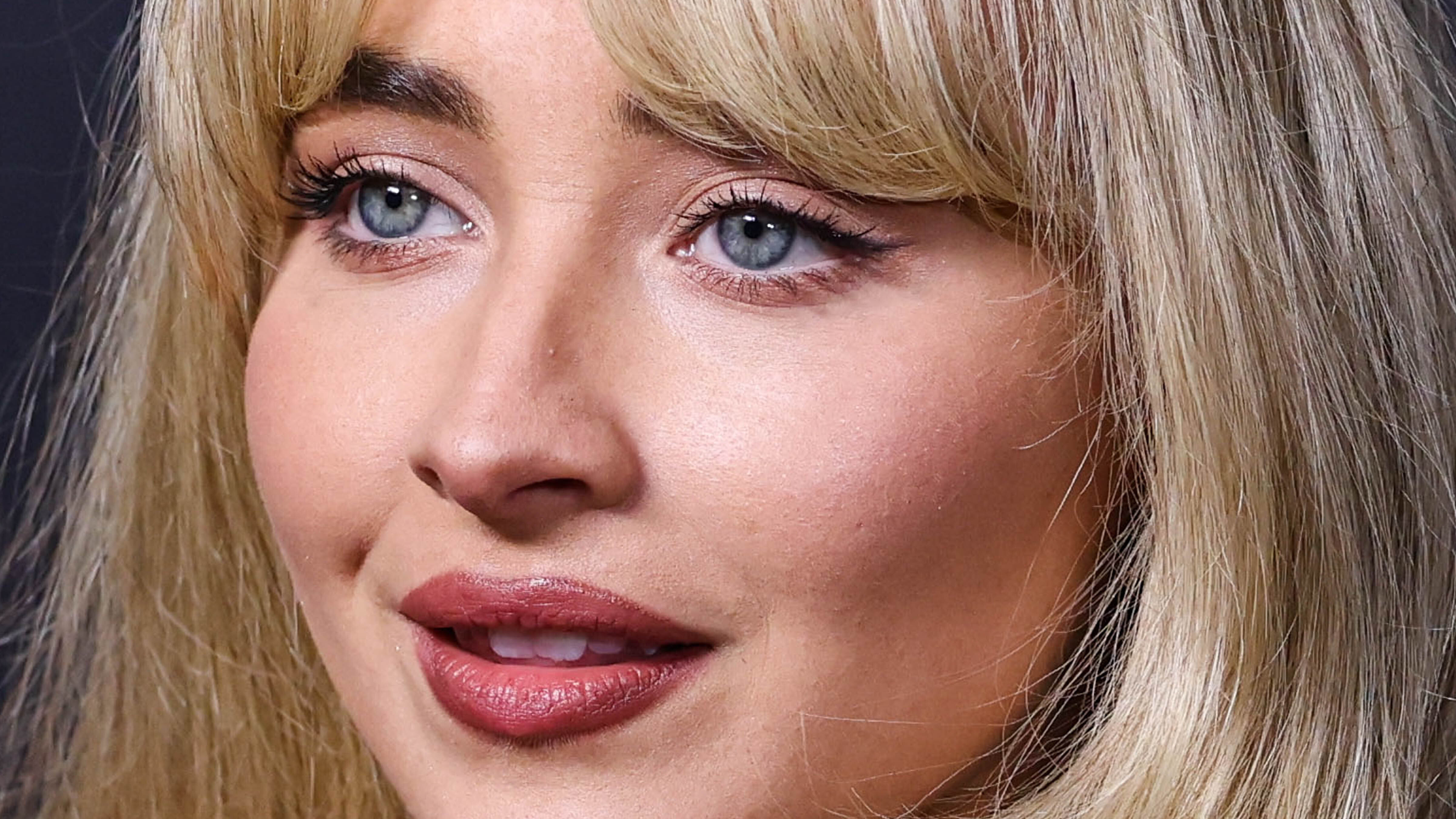 A close-up shot of Sabrina Carpenter smiling