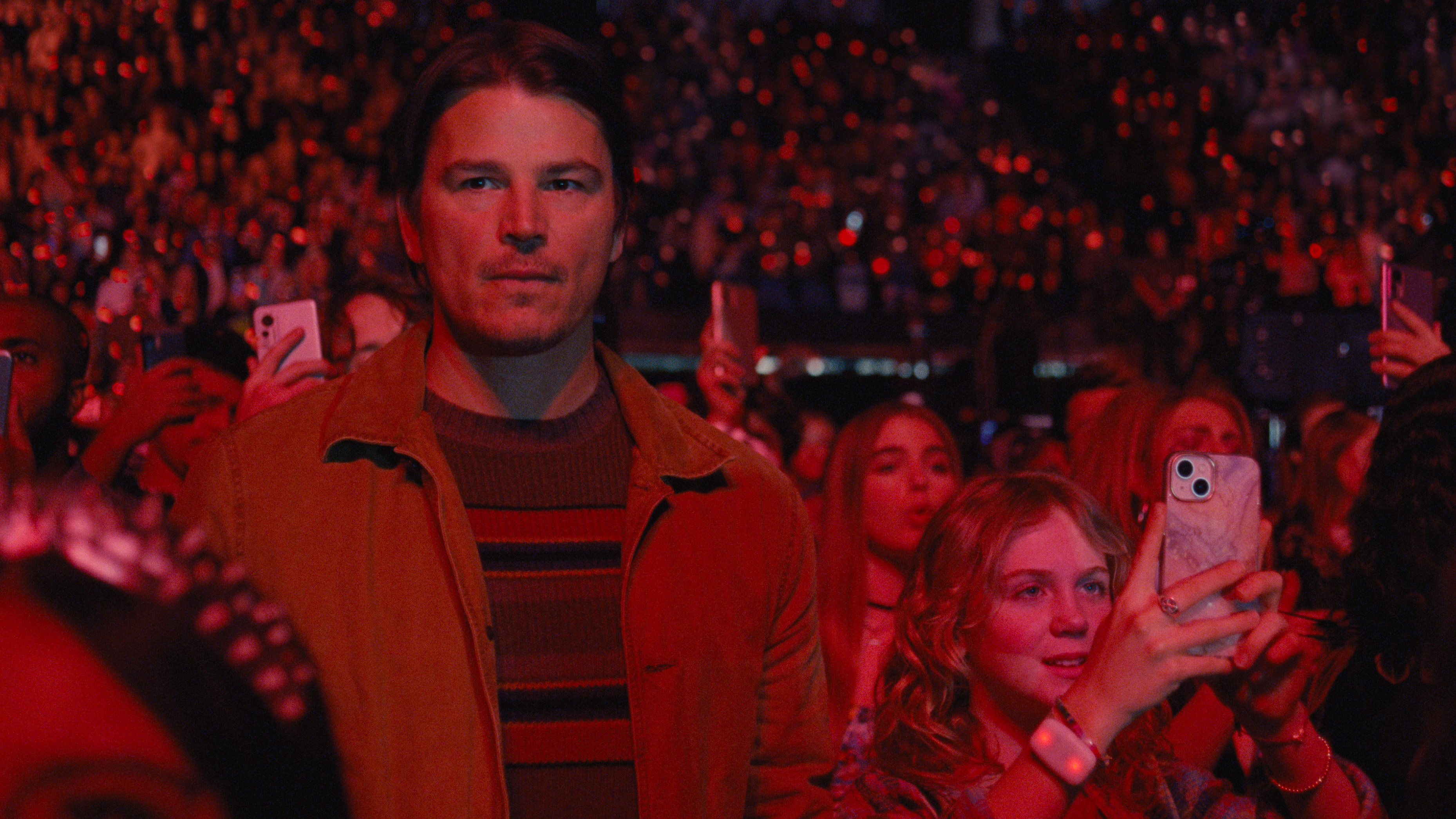 Josh Hartnett, the protagonist in Trap, stands next to his teenage daughter at a concert