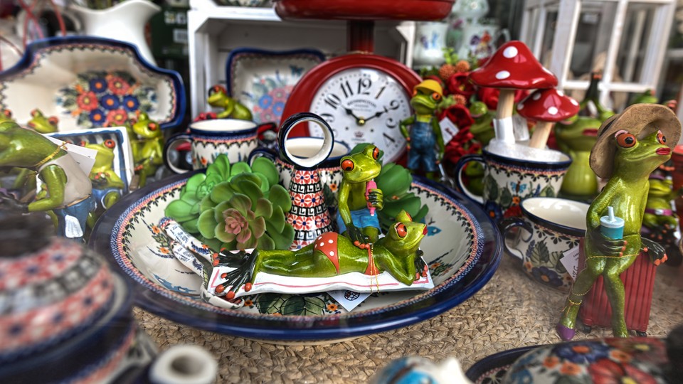 Multiple ceramic frog figurines on a table