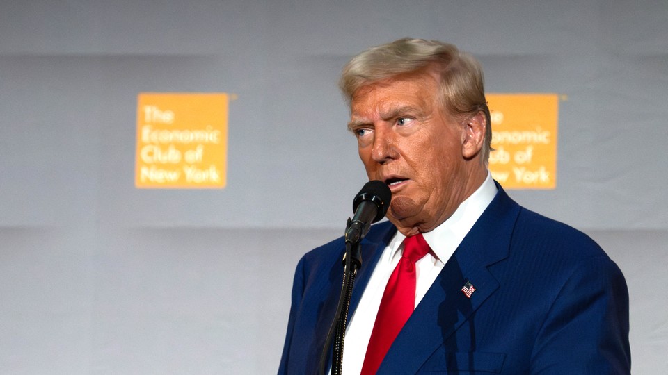 Donald Trump looks to the side while speaking at the Economic Club of New York