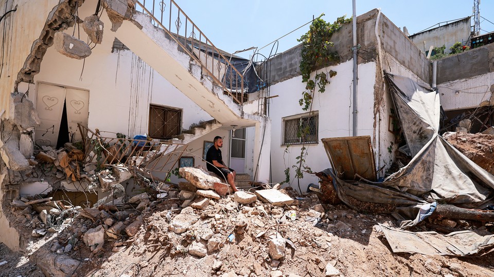 A Palestinian man checks the destruction following an Israeli raid on Jenin, in the occupied West Bank, on August 6, 2024.