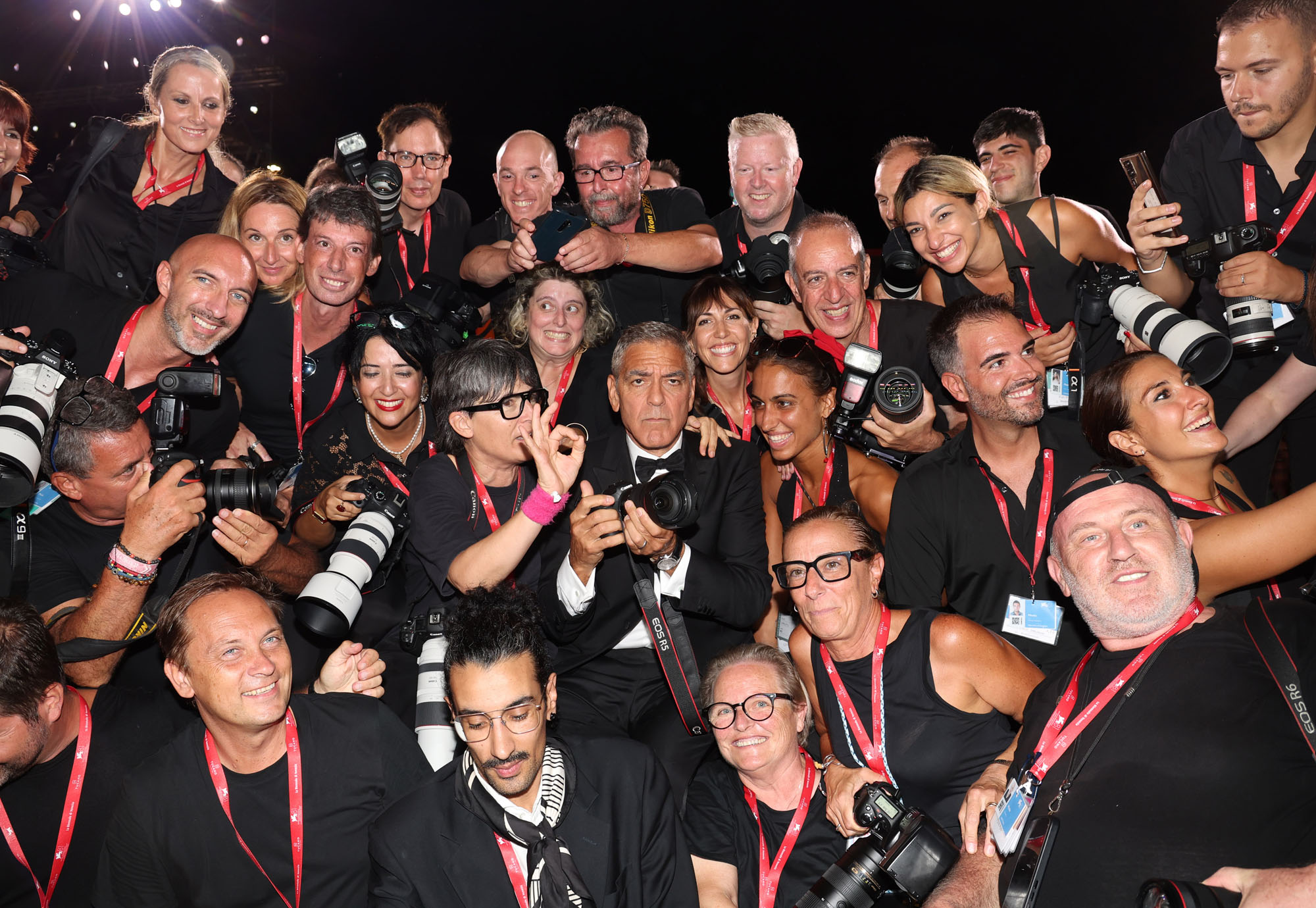 George Clooney poses with photographers as he attends the Wolfs red carpet during the Venice International Film Festival.