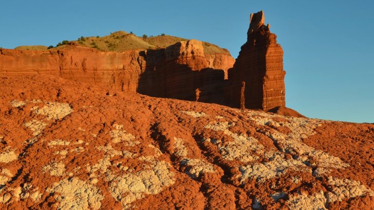 An orange rock formation on sunny day