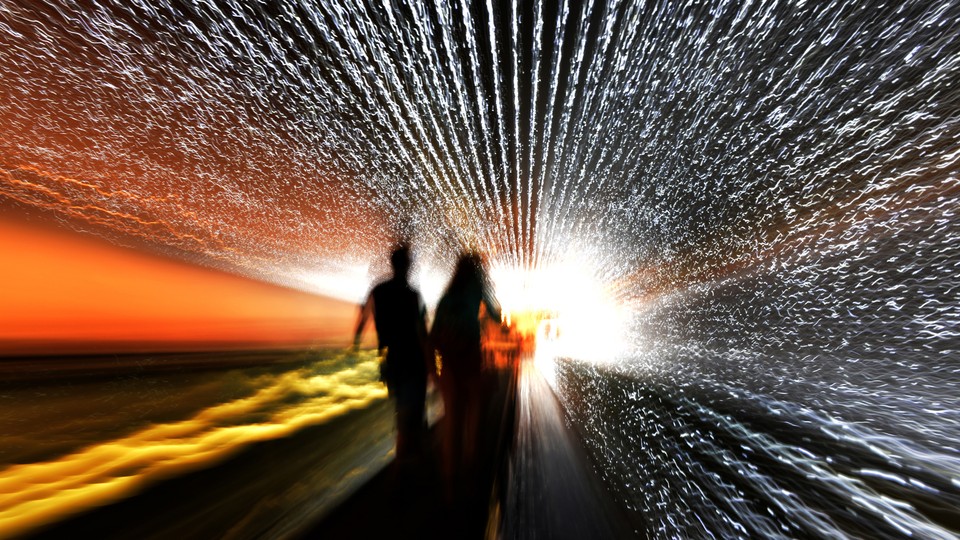 Two figures going through a blurry tunnel toward the light