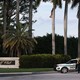 A sheriff's deputy stands outside Trump International Golf Club