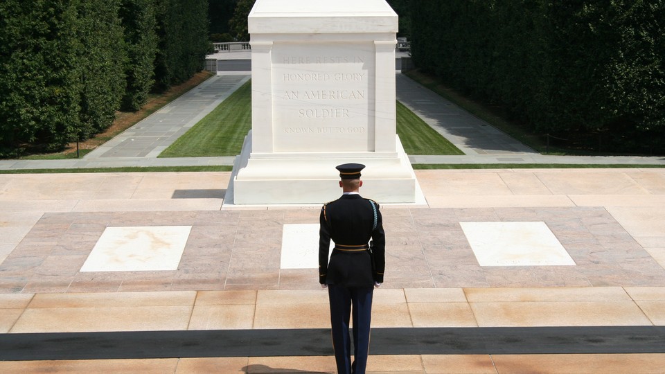 A soldier stands in front of the Tomb of the Unknown Soldier