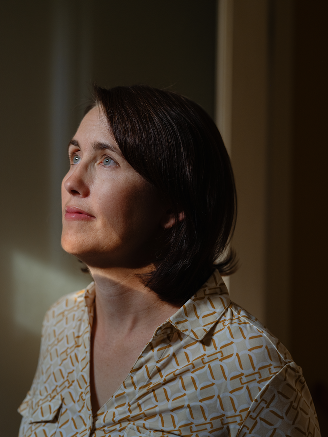 photo of dark-haired woman in 3/4 profile looking up