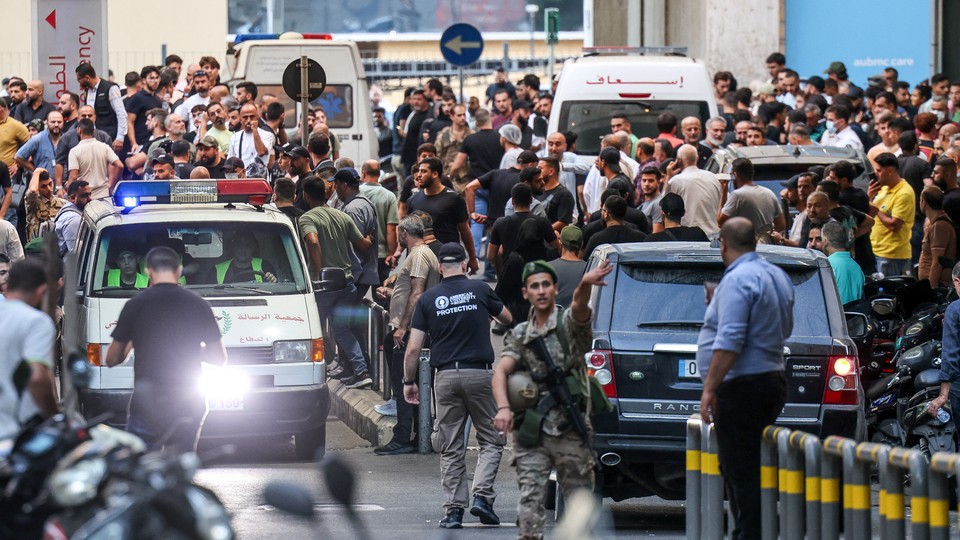 Crowds and confusion gather around ambulances in Beirut.