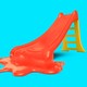 A graphic illustration of a red plastic play slide, with the bottom of it melting into a puddle.