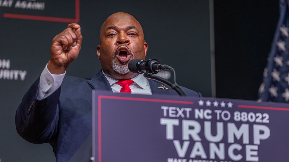 Mark Robinson speaks in front of a Trump-Vance podium