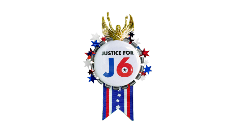 A red, white, and blue medal with text reading 'Justice For J6.'