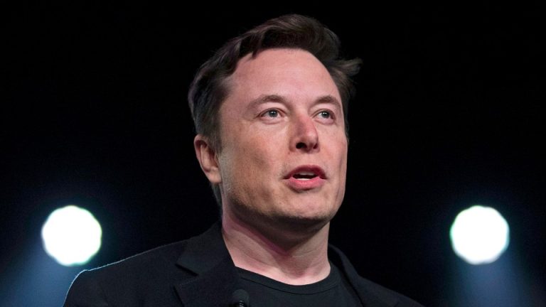 A close-up shot of Elon Musk against a dark background