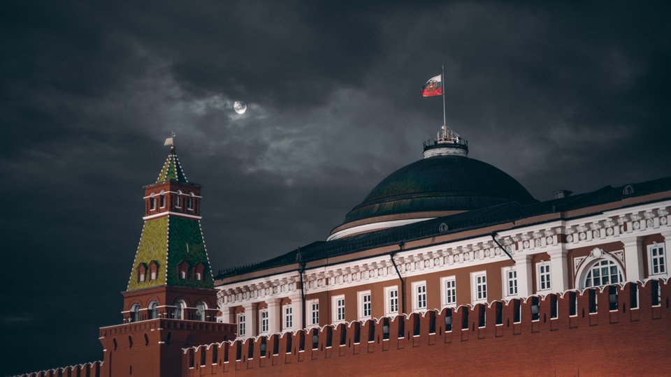 An image of the Kremlin in front of a cloudy dark night sky