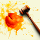 A judge's gavel next to a smashed peach