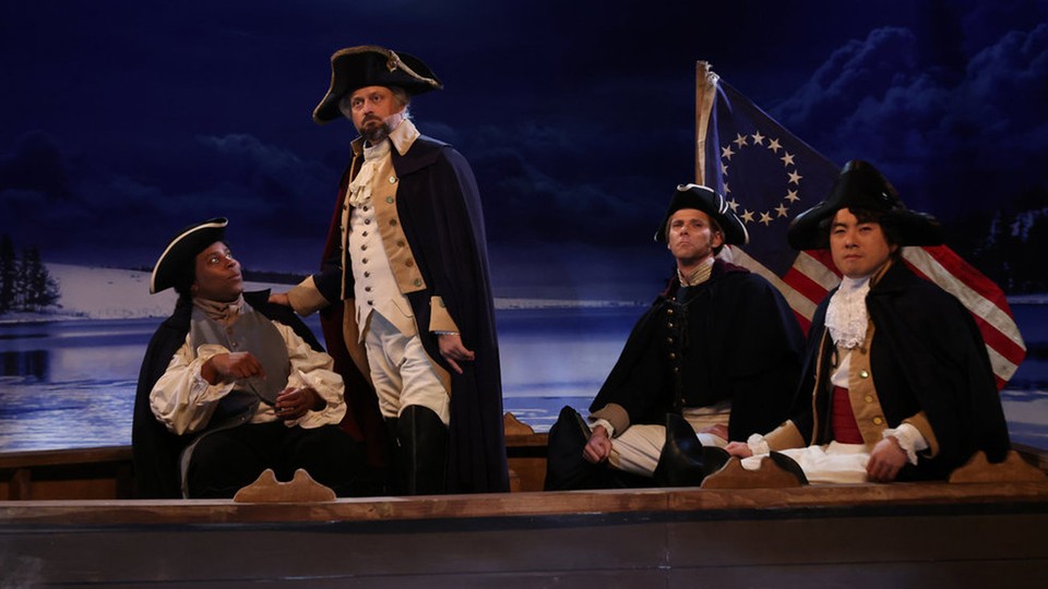 Four men on a boat in revolutionary-war clothing with an old American flag and a deep-blue stage backdrop.