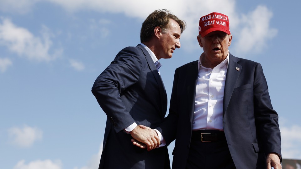 A photograph shoes Glenn Youngkin shaking Donald Trump's hand