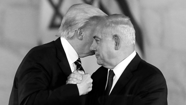 Trump clasps Netanyahu's hand and leans close to speak in his ear.